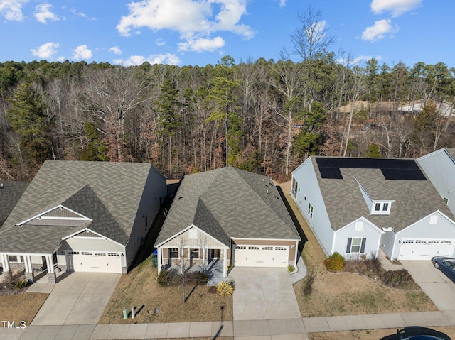 bird's eye view featuring a wooded view