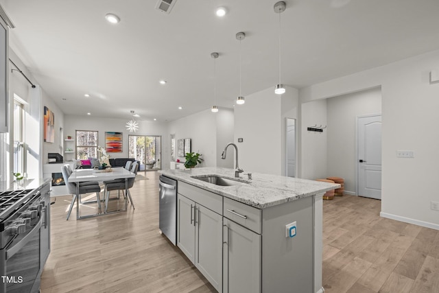 kitchen with visible vents, a sink, open floor plan, gas range, and dishwasher