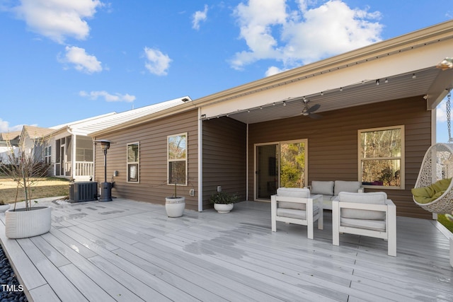 wooden terrace with central air condition unit, outdoor lounge area, and ceiling fan