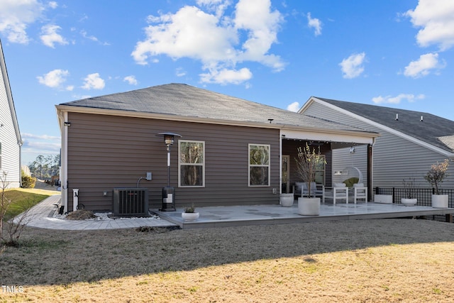 back of house with a lawn, central AC, and a patio area