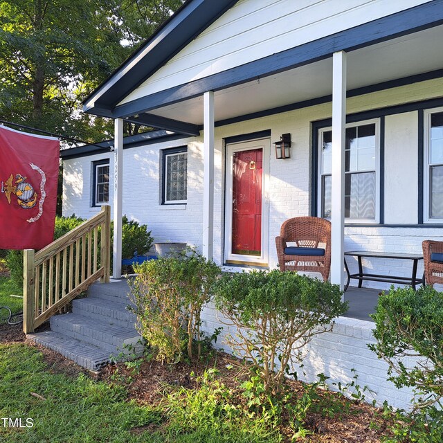 entrance to property featuring covered porch