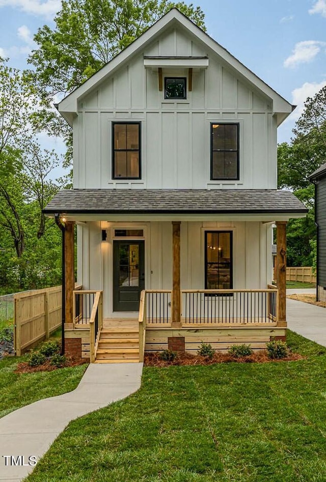 modern farmhouse featuring a porch and a front lawn