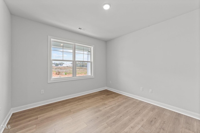 spare room featuring light hardwood / wood-style flooring