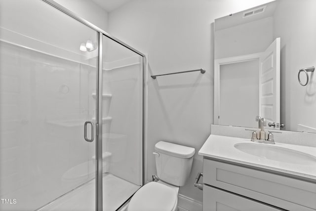 bathroom featuring vanity, an enclosed shower, and toilet