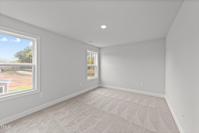 spare room with light colored carpet