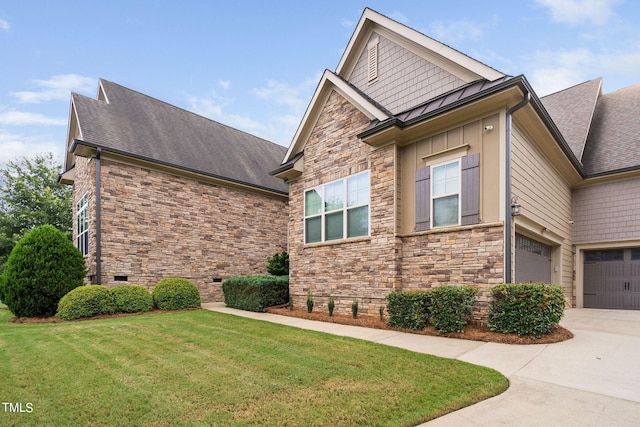 view of home's exterior with a yard and a garage