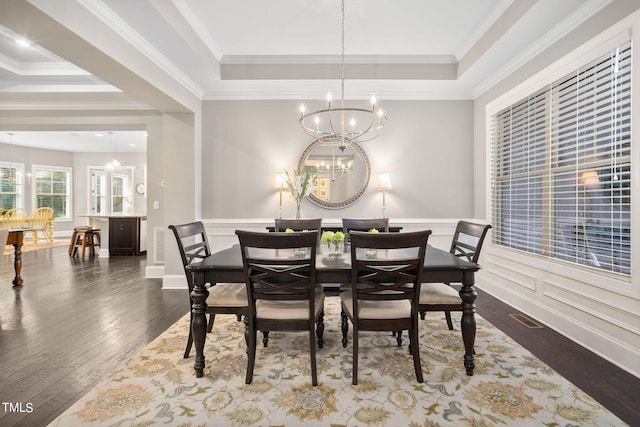 dining space featuring a chandelier, dark hardwood / wood-style floors, and ornamental molding