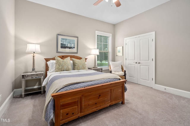 carpeted bedroom featuring ceiling fan and a closet