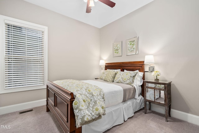 bedroom featuring light carpet and ceiling fan