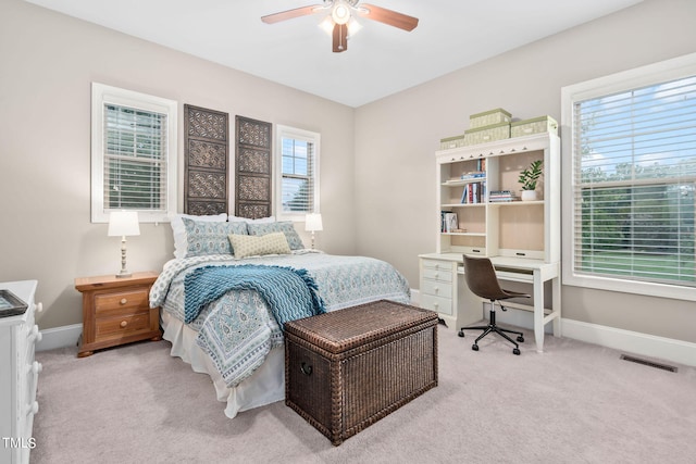 bedroom with ceiling fan and light colored carpet