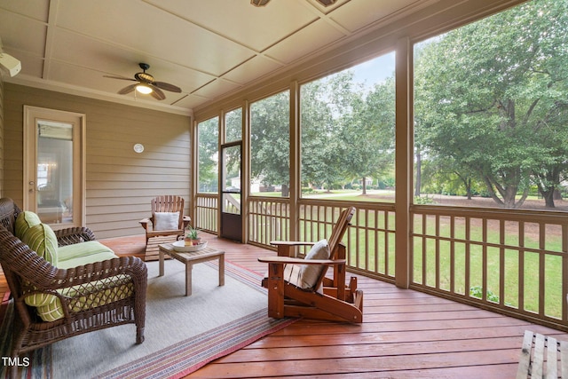 sunroom with plenty of natural light and ceiling fan