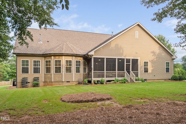 back of property featuring a sunroom and a yard