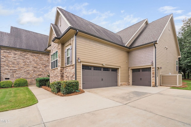 view of side of home featuring a garage