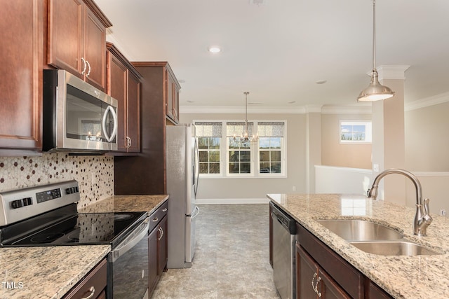 kitchen featuring sink, decorative light fixtures, light stone counters, and appliances with stainless steel finishes