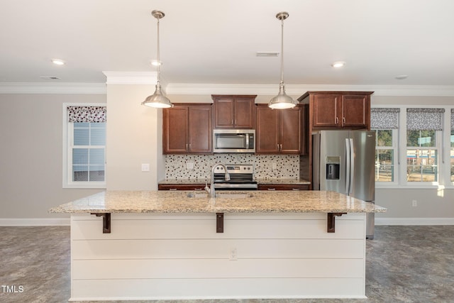 kitchen with light stone countertops, decorative light fixtures, stainless steel appliances, crown molding, and sink