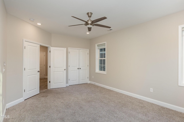 unfurnished bedroom featuring ceiling fan and carpet