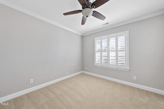 carpeted empty room featuring ceiling fan and ornamental molding