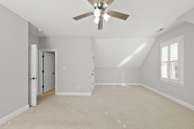 additional living space featuring ceiling fan, light colored carpet, and lofted ceiling