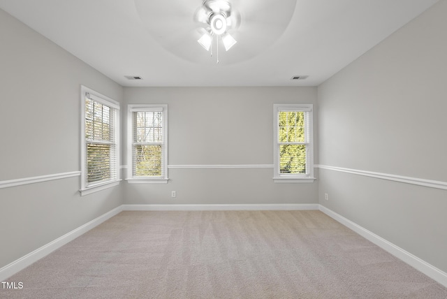 carpeted spare room with ceiling fan