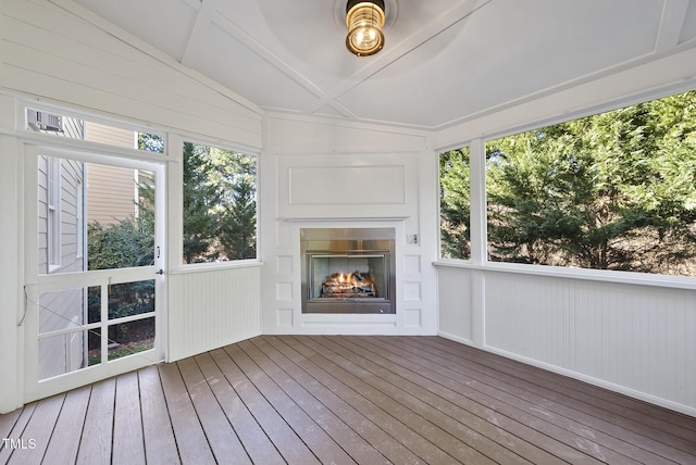 unfurnished sunroom featuring ceiling fan and vaulted ceiling