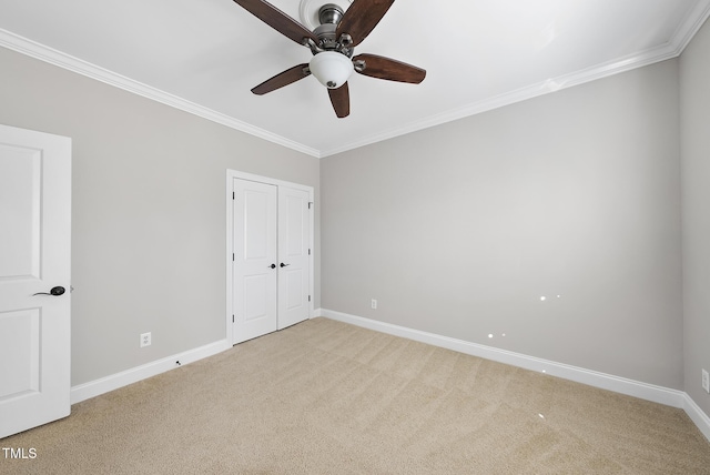 unfurnished bedroom with ceiling fan, a closet, light carpet, and ornamental molding