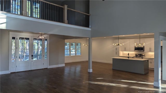 foyer featuring french doors, plenty of natural light, a high ceiling, and sink