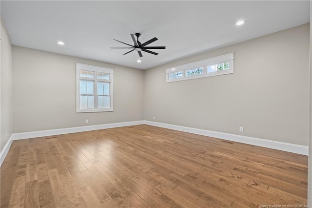 unfurnished room with a ceiling fan, baseboards, wood finished floors, and recessed lighting