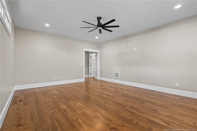 spare room with ceiling fan, recessed lighting, wood finished floors, visible vents, and baseboards