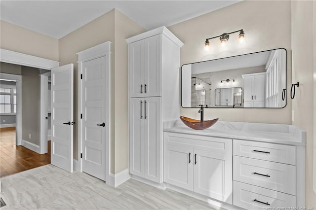 bathroom featuring vanity and baseboards