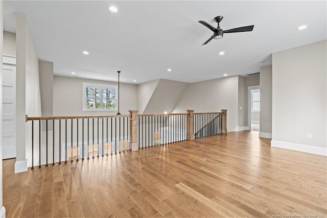 spare room featuring light wood finished floors, ceiling fan, baseboards, and recessed lighting