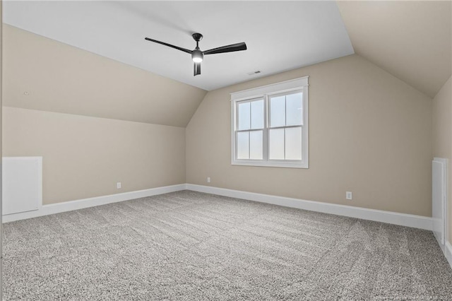 additional living space featuring vaulted ceiling, carpet floors, and baseboards