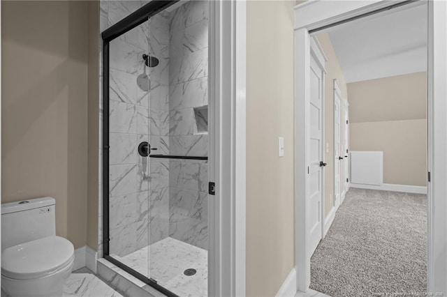 full bath with baseboards, toilet, and a marble finish shower