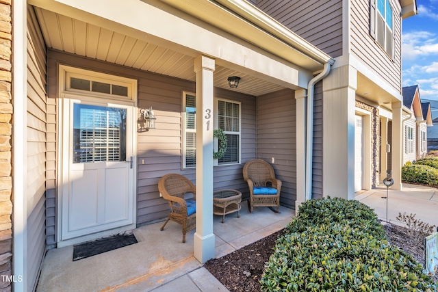 view of exterior entry with covered porch