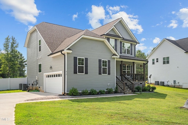 craftsman-style house featuring covered porch, central AC, a garage, and a front lawn