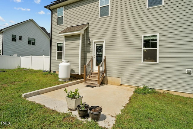 back of property featuring a yard and a patio area