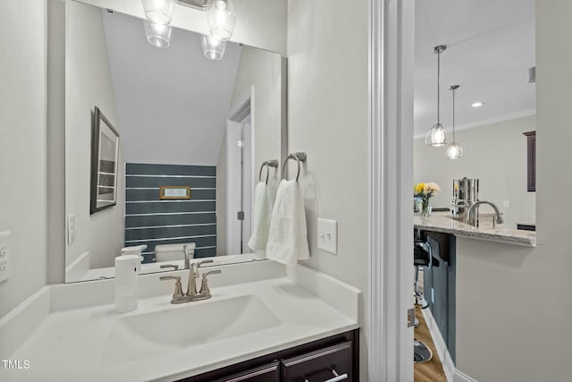 bathroom featuring vanity, toilet, and ornamental molding