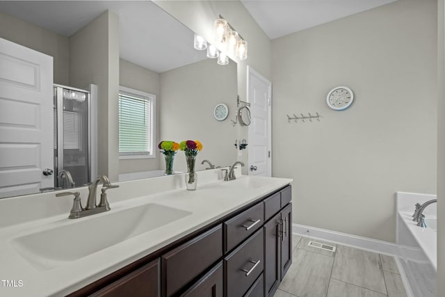 bathroom with vanity and independent shower and bath