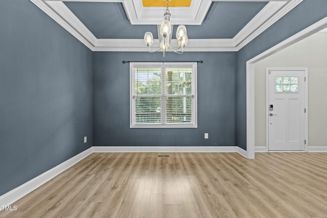 entryway with a raised ceiling, light hardwood / wood-style flooring, an inviting chandelier, and ornamental molding