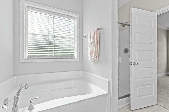 bathroom with tile patterned floors, a healthy amount of sunlight, and independent shower and bath