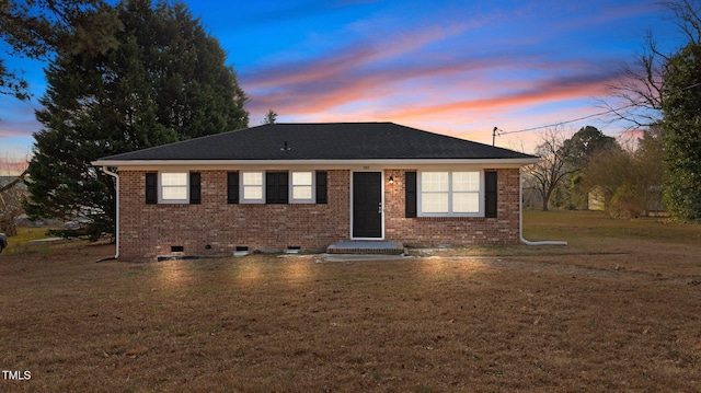 ranch-style home with a yard