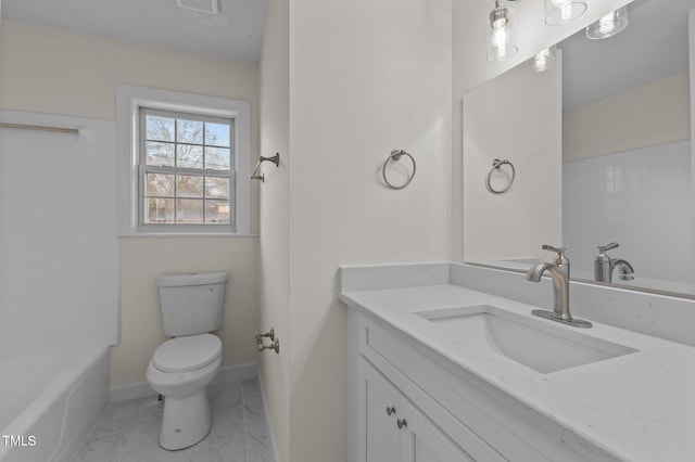 bathroom with vanity, toilet, and a textured ceiling