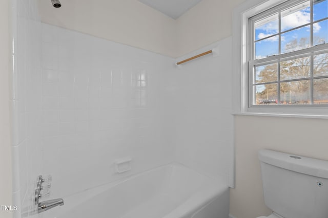 bathroom featuring shower / bathing tub combination and toilet