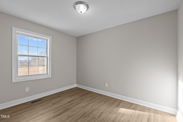 unfurnished room with light wood-type flooring