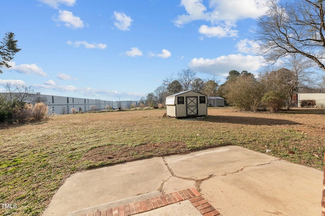 view of yard with a patio and a storage shed