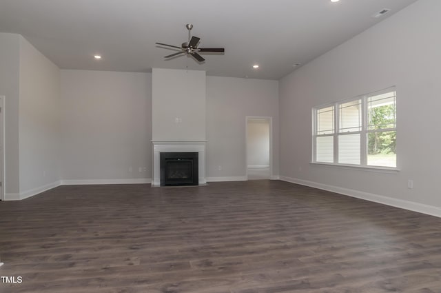 unfurnished living room with ceiling fan and dark hardwood / wood-style flooring