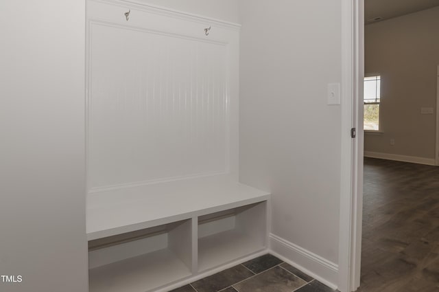 mudroom with dark tile patterned flooring