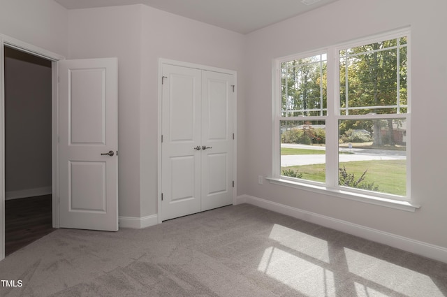 unfurnished bedroom featuring a closet and carpet flooring