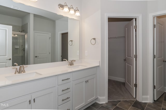 bathroom featuring vanity, tile patterned floors, and walk in shower