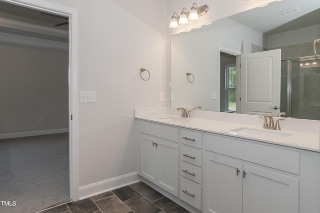 bathroom featuring tile patterned floors, a shower with door, and vanity