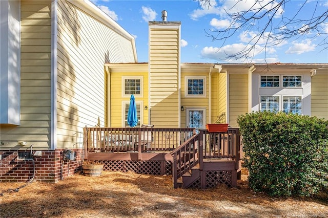 back of house featuring a deck